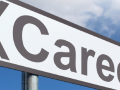 Street sign that says "Career" against a background of a blue sky with clouds.