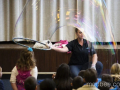 A Bubblologist makes a huge bubble in front of children.