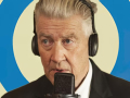 david lynch wearing headphones talking into a mic
