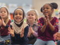 Seated children smiling and clapping