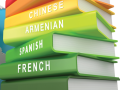 A stack of books with languages on the spines