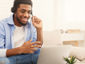 man wearing a headset while sitting in front of a laptop