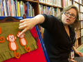 A woman pointing to a storyboard with monkeys.