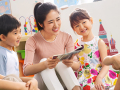 young woman volunteer with four students