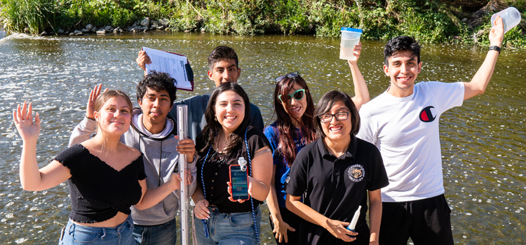 teens participating in a water transparency exercise by the LA River